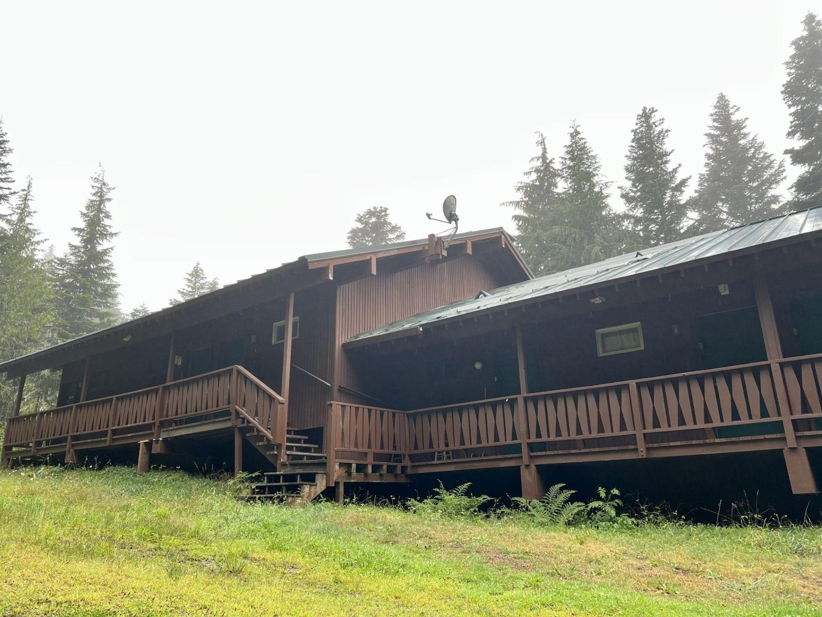 The club building in the trees on a misty day